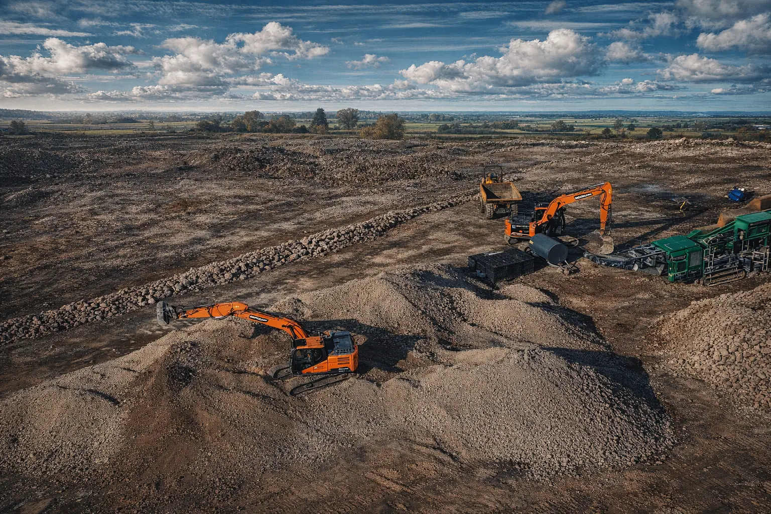 Multiple excavators and loader working under blue sky