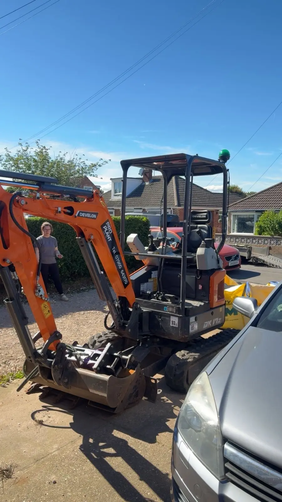 Pro Plant Develon mini excavator on a domestic driveway